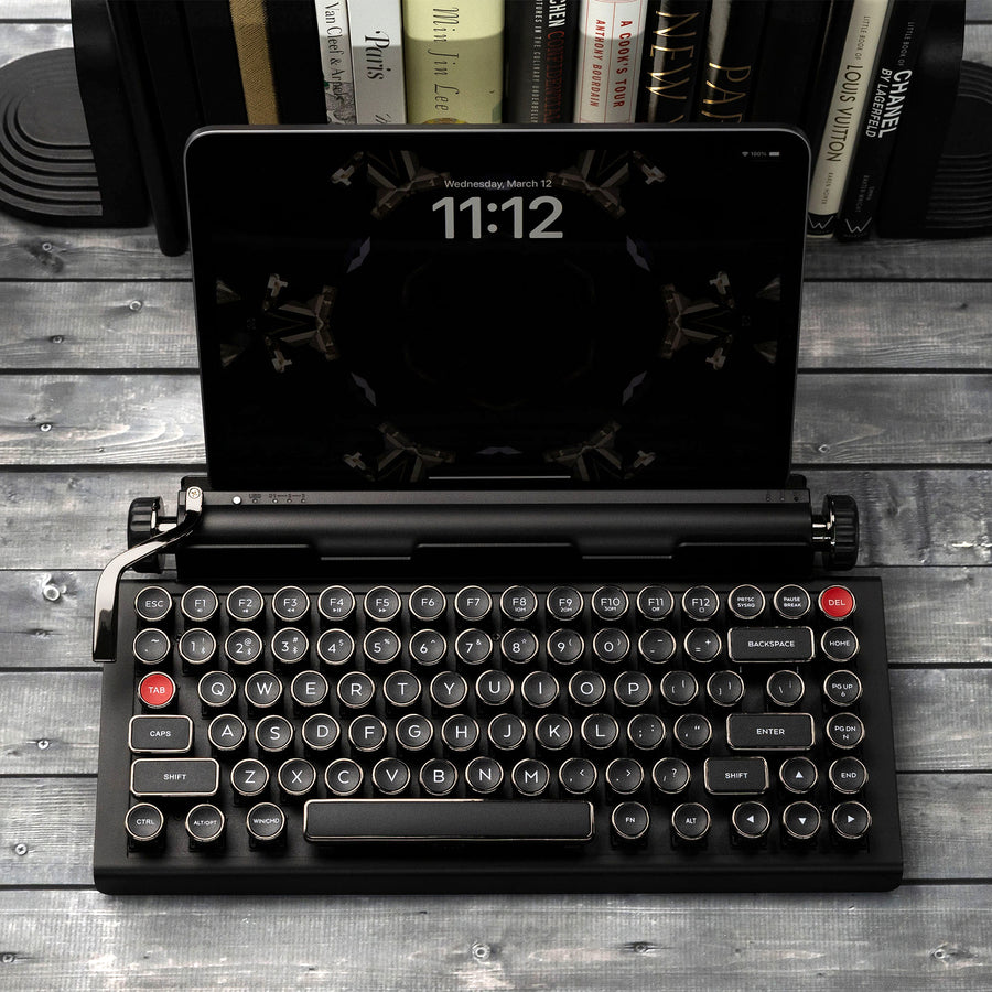 Qwerkywriter typewriter keyboard best in class premium all aluminum body in anniversary dark chrome on grey wood grain background with iPad ios Android Samsung Tablet up to 13 inches