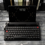 Qwerkywriter typewriter keyboard best in class premium all aluminum body in anniversary dark chrome on grey wood grain background with iPad ios Android Samsung Tablet up to 13 inches