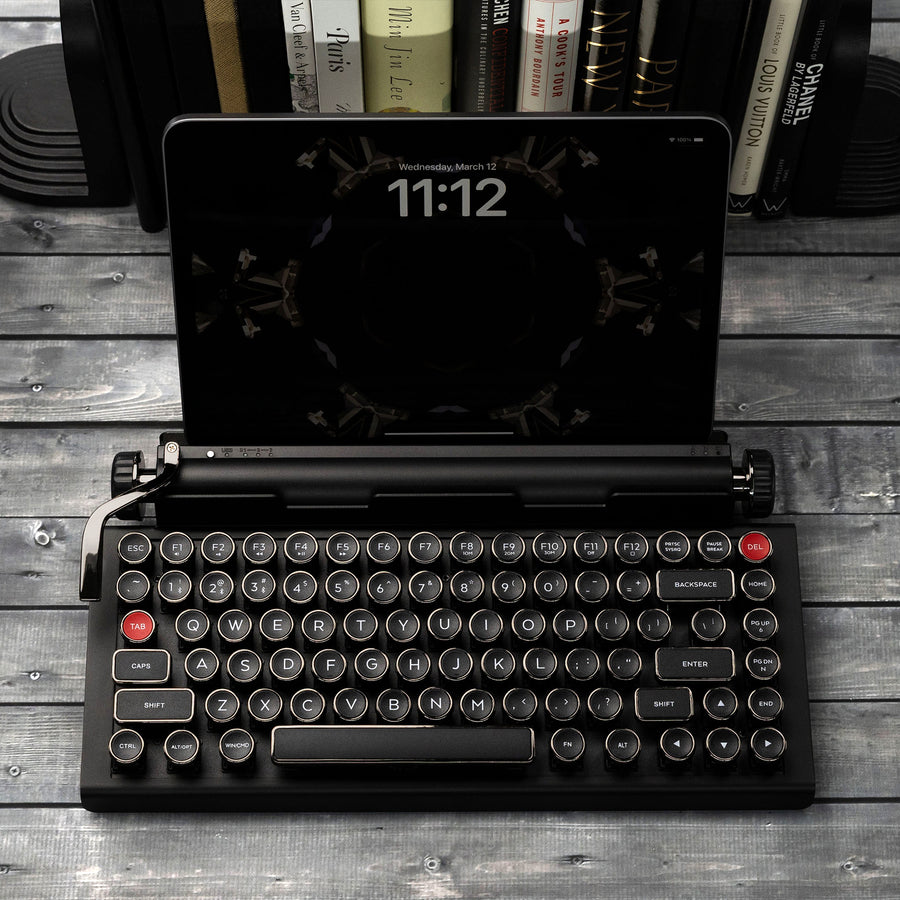 Qwerkywriter typewriter keyboard best in class premium all aluminum body in anniversary dark chrome on grey wood grain background with iPad ios Android Samsung Tablet up to 13 inches