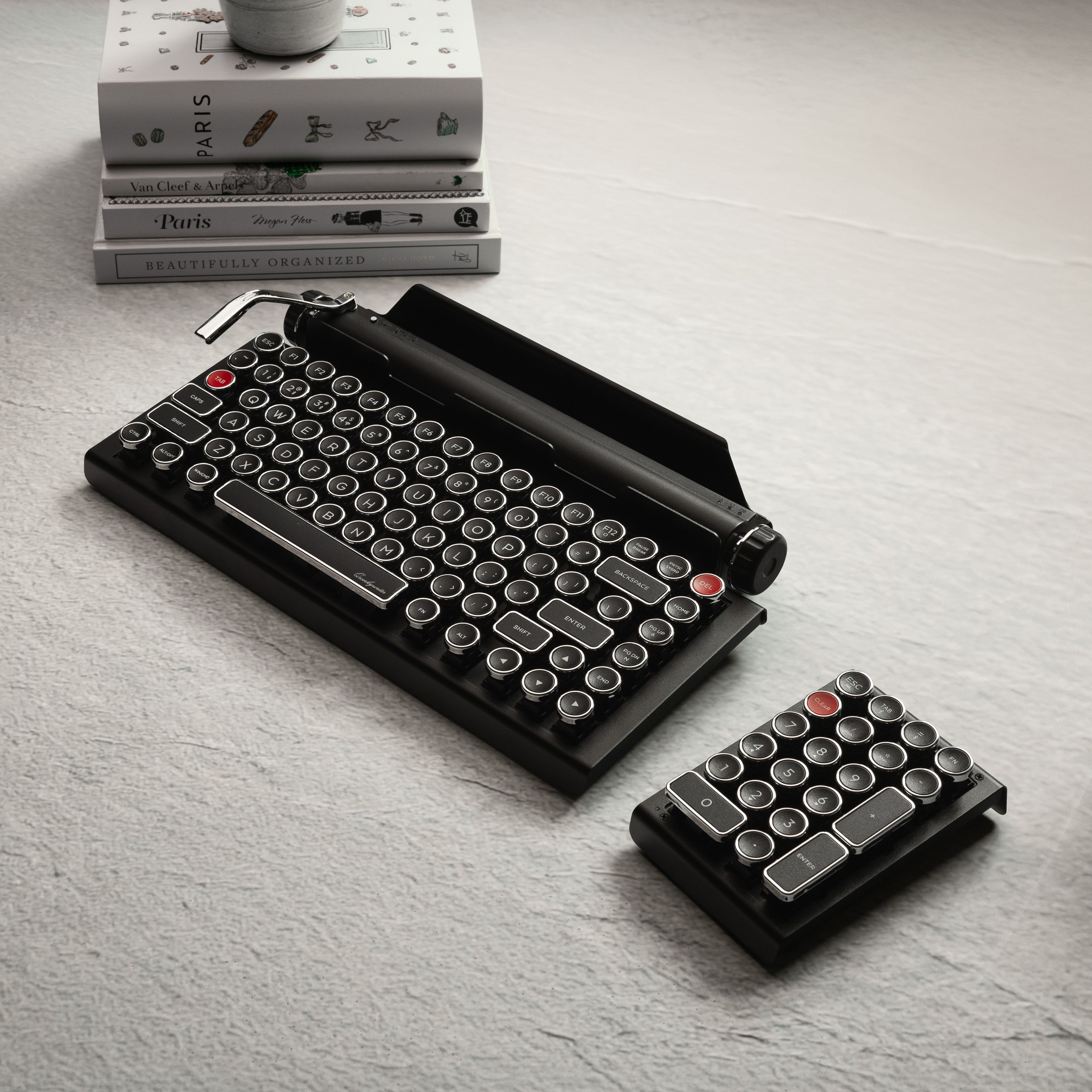 Qwerkywriter typewriter keyboard best in class premium all aluminum body in black chrome on grey wood grain background with hot swap tool and cherry mx blue switch Alt angle full set view