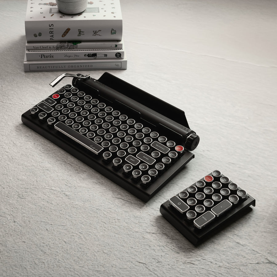 Qwerkywriter typewriter keyboard best in class premium all aluminum body in black chrome on grey wood grain background with hot swap tool and cherry mx blue switch Alt angle full set view