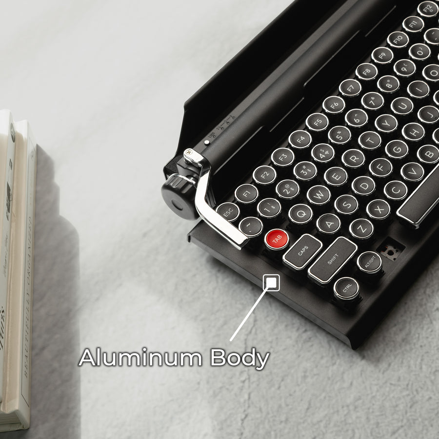 Qwerkywriter typewriter keyboard best in class premium all aluminum body in black chrome on brown wood grain background aluminum chassis body