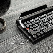 Qwerkywriter typewriter keyboard best in class premium all aluminum body in black chrome on brown wood grain background aluminum chassis body