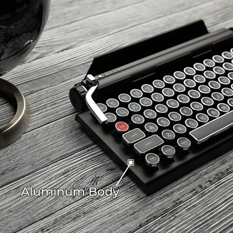 Qwerkywriter typewriter keyboard best in class premium all aluminum body in black chrome on brown wood grain background aluminum chassis body