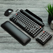 Qwerkywriter typewriter keyboard best in class premium all aluminum body in white chrome on grey wood grain background complete desktop with Qwerkywriter Official Wrist Rest and Black Chrome Numkey