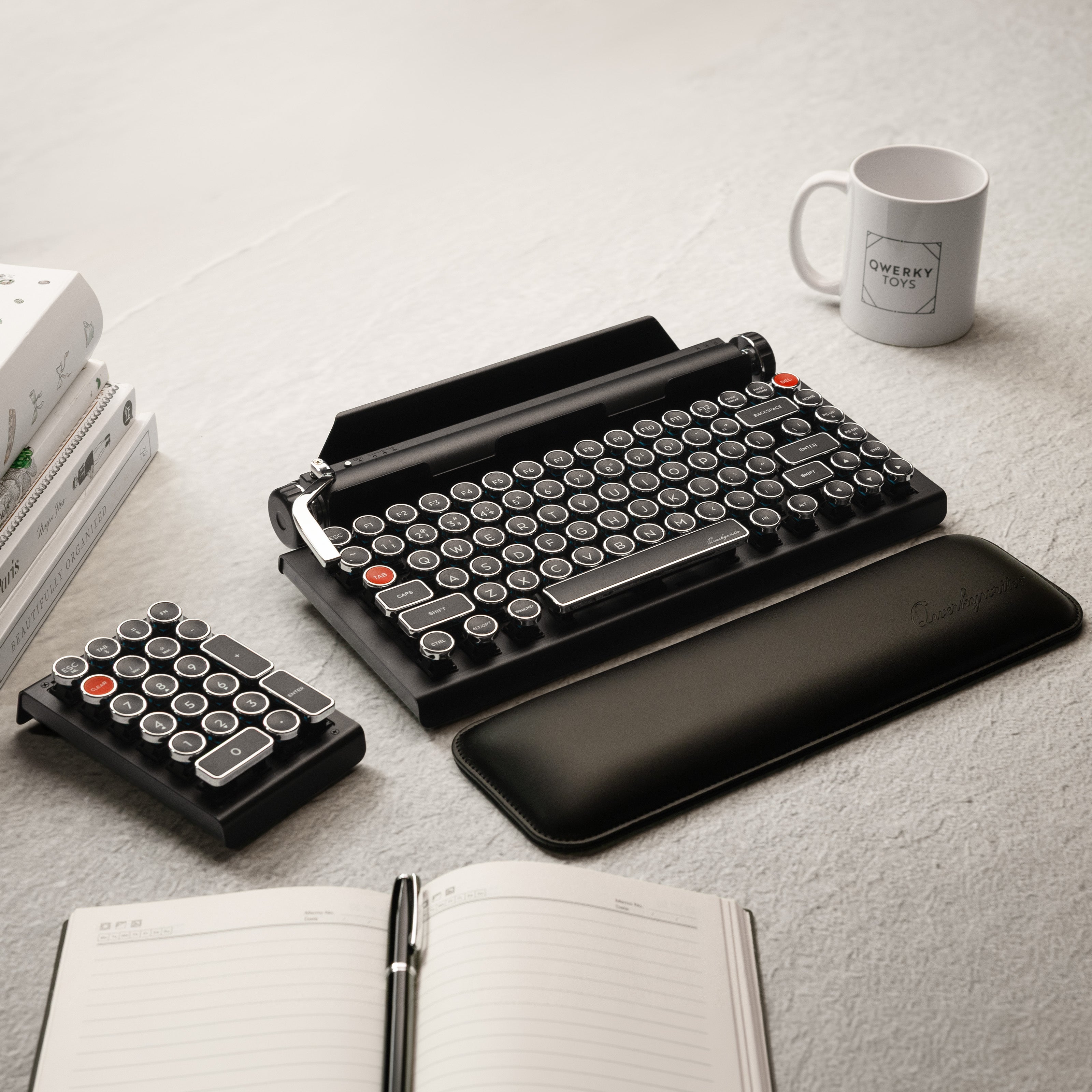 Qwerkywriter typewriter keyboard best in class premium all aluminum body in white chrome on grey wood grain background complete desktop with Qwerkywriter Official Wrist Rest and Black Chrome Numkey