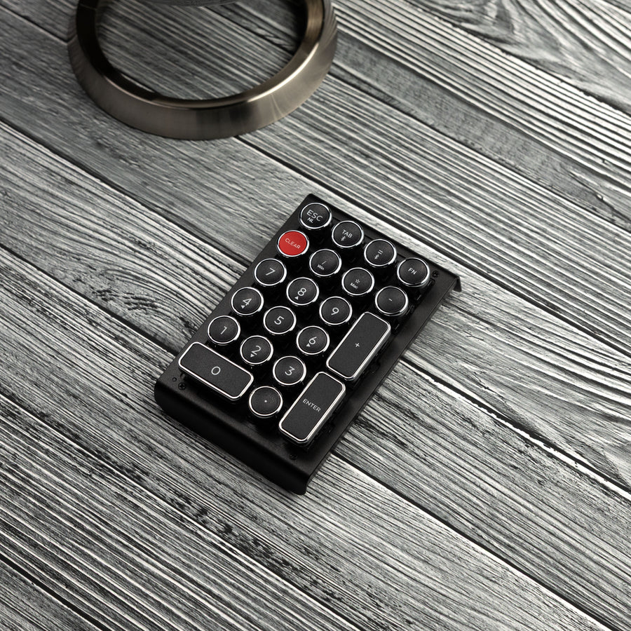 Qwerkywriter typewriter keyboard numkey numpad best in class premium all aluminum body in black chrome left view on grey wood grain