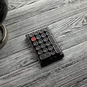 Qwerkywriter typewriter keyboard numkey numpad best in class premium all aluminum body in black chrome right side view on grey wood grain 