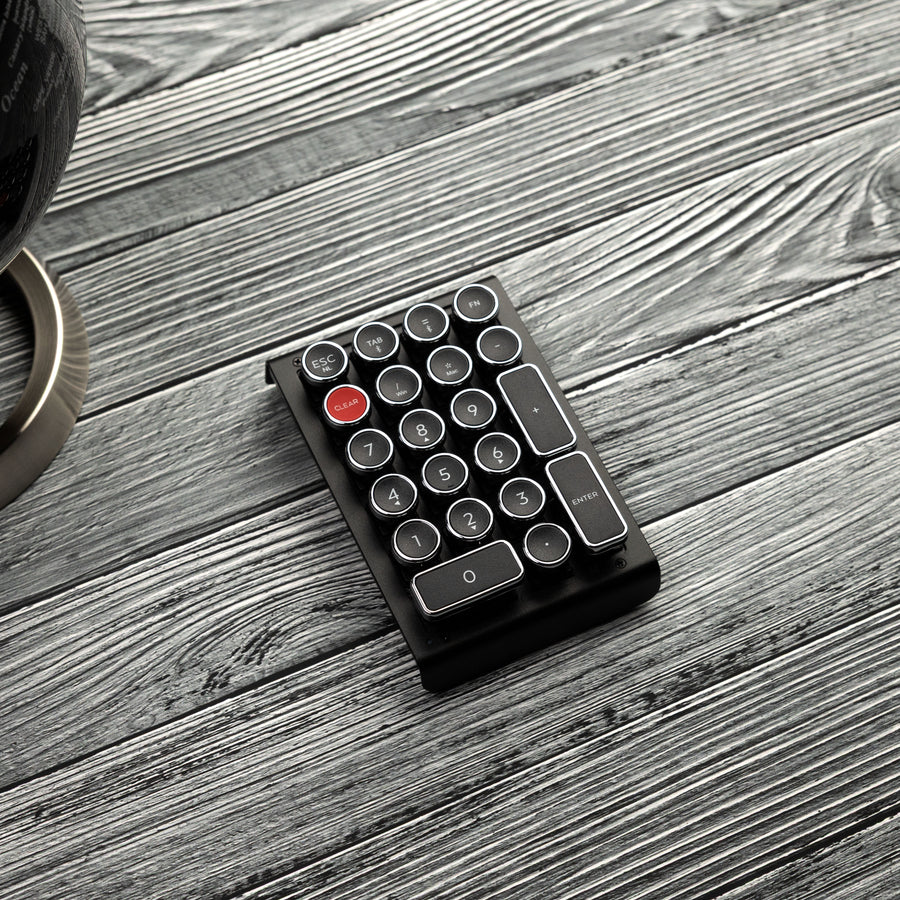 Qwerkywriter typewriter keyboard numkey numpad best in class premium all aluminum body in black chrome right side view on grey wood grain 