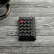 Qwerkywriter typewriter keyboard numkey numpad best in class premium all aluminum body in black chrome top view on grey wood grain