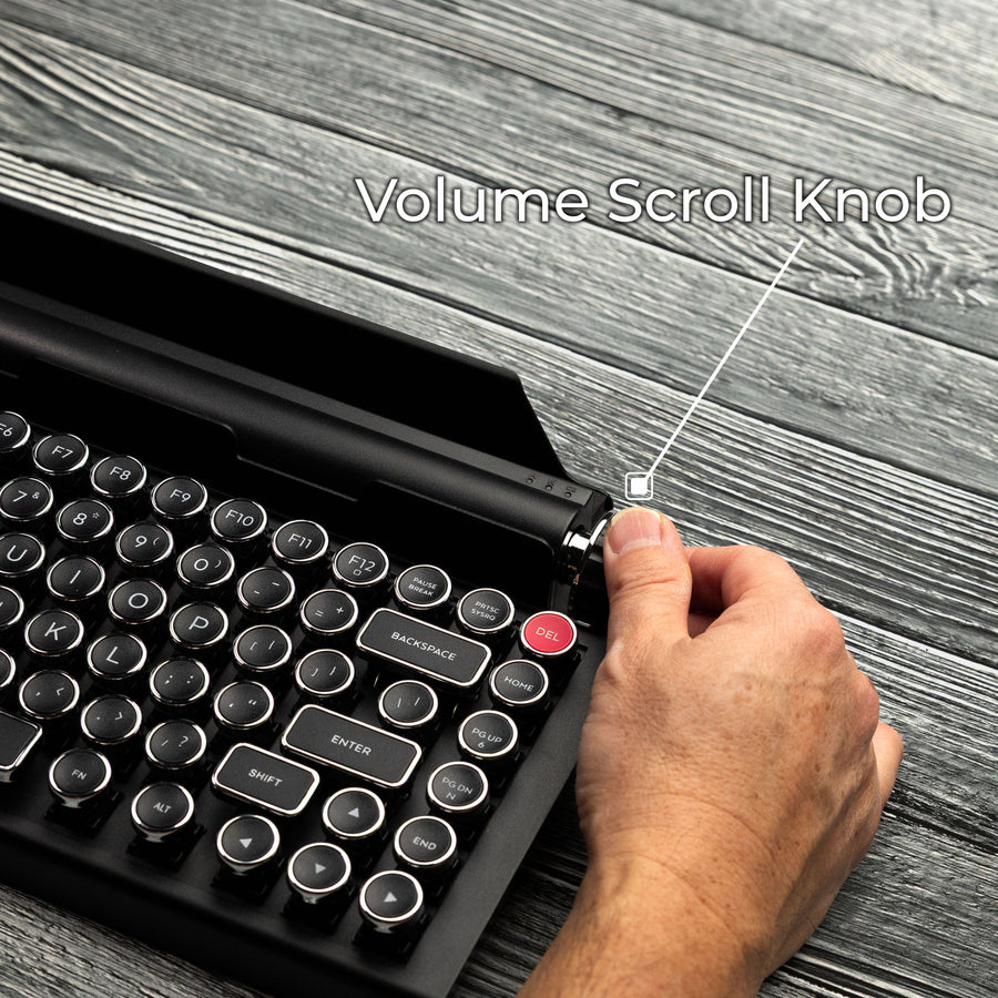 Qwerkywriter typewriter keyboard best in class premium all aluminum body in black chrome on grey wood grain background page scroll and volume knob