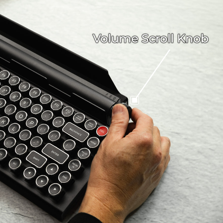Qwerkywriter typewriter keyboard best in class premium all aluminum body in black chrome on grey wood grain background page scroll and volume knob