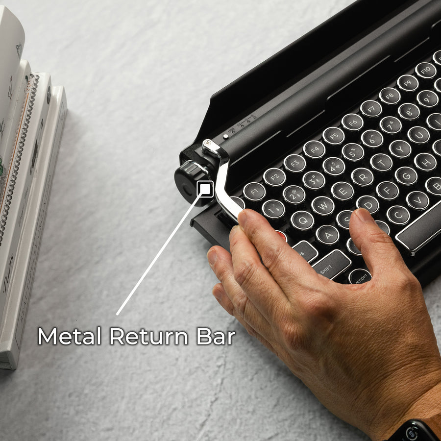 Qwerkywriter typewriter keyboard best in class premium all aluminum body in black chrome on grey wood grain background with all metal macro programmable return bar
