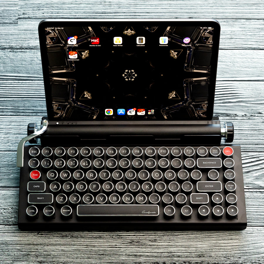 qwerkywriter typewriter keyboard best in class premium all aluminum body in black chrome on grey wood grain background with tablet stand heavy duty accommodate up to 13 inch tablet and 5/8 inches thick