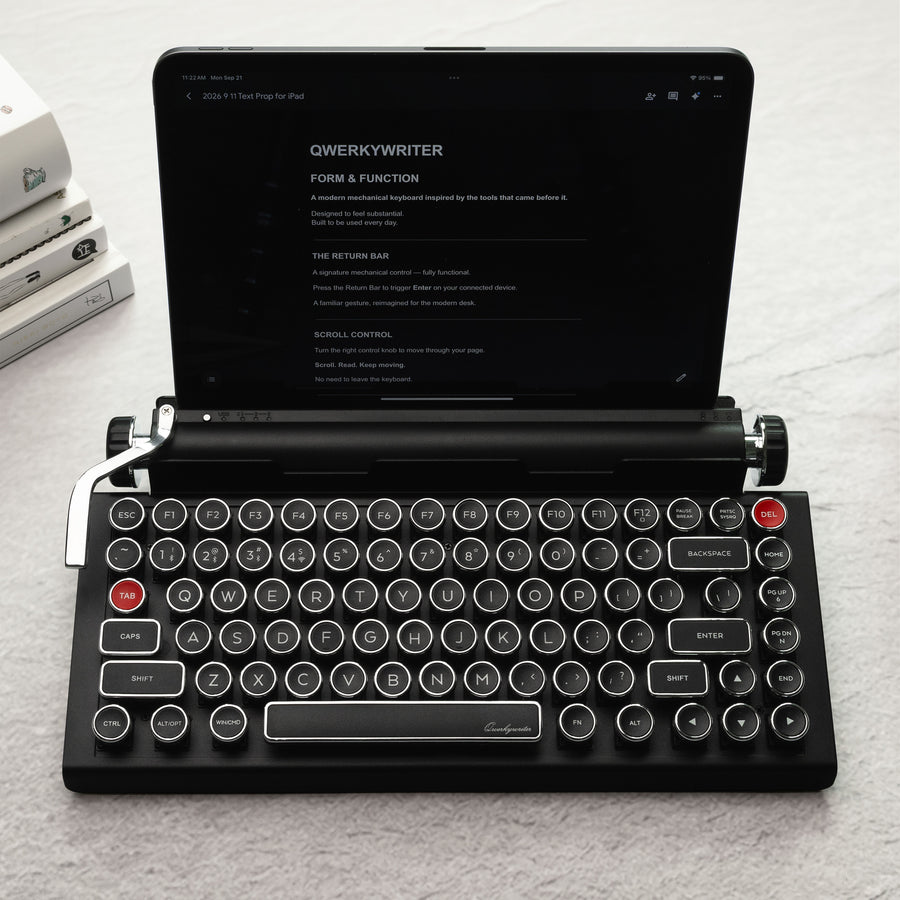 qwerkywriter typewriter keyboard best in class premium all aluminum body in black chrome on grey wood grain background with tablet stand heavy duty accommodate up to 13 inch tablet and 5/8 inches thick
