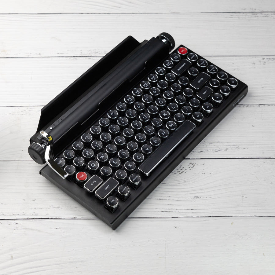 Qwerkywriter typewriter keyboard best in class premium all aluminum body in black chrome on white wood background US ANSI layout