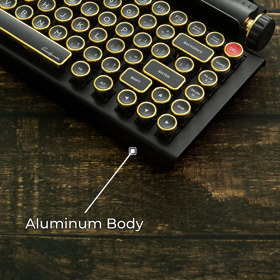 Qwerkywriter typewriter keyboard best in class premium all aluminum body in black gold on brown wood grain background aluminum chassis body