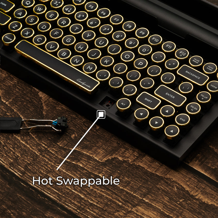 Qwerkywriter typewriter keyboard best in class premium all aluminum body in black gold close up view of hot swappable switches on brown wood grain background