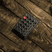 Qwerkywriter typewriter keyboard numkey numpad best in class premium all aluminum body in black chrome right side view on brown wood grain 