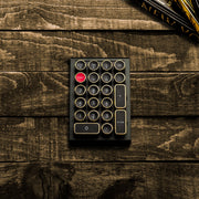 Qwerkywriter typewriter keyboard numkey numpad best in class premium all aluminum body in black gold top view on brown wood grain