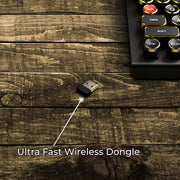 Qwerkywriter typewriter keyboard best in class premium all aluminum body in black gold on brown wood grain background ultra fast wireless dongle lagless no lag