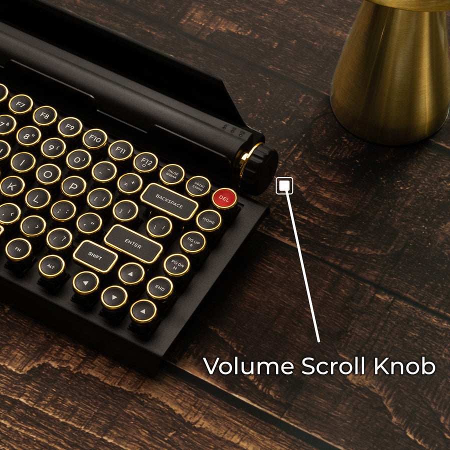 Qwerkywriter typewriter keyboard best in class premium all aluminum body in black gold close up view of volume scroll knob on brown wood grain background