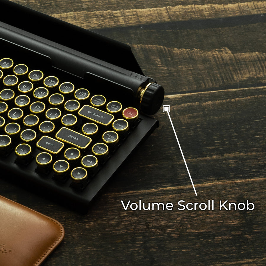 Qwerkywriter typewriter keyboard best in class premium all aluminum body in black gold close up view of volume scroll knob on brown wood grain background
