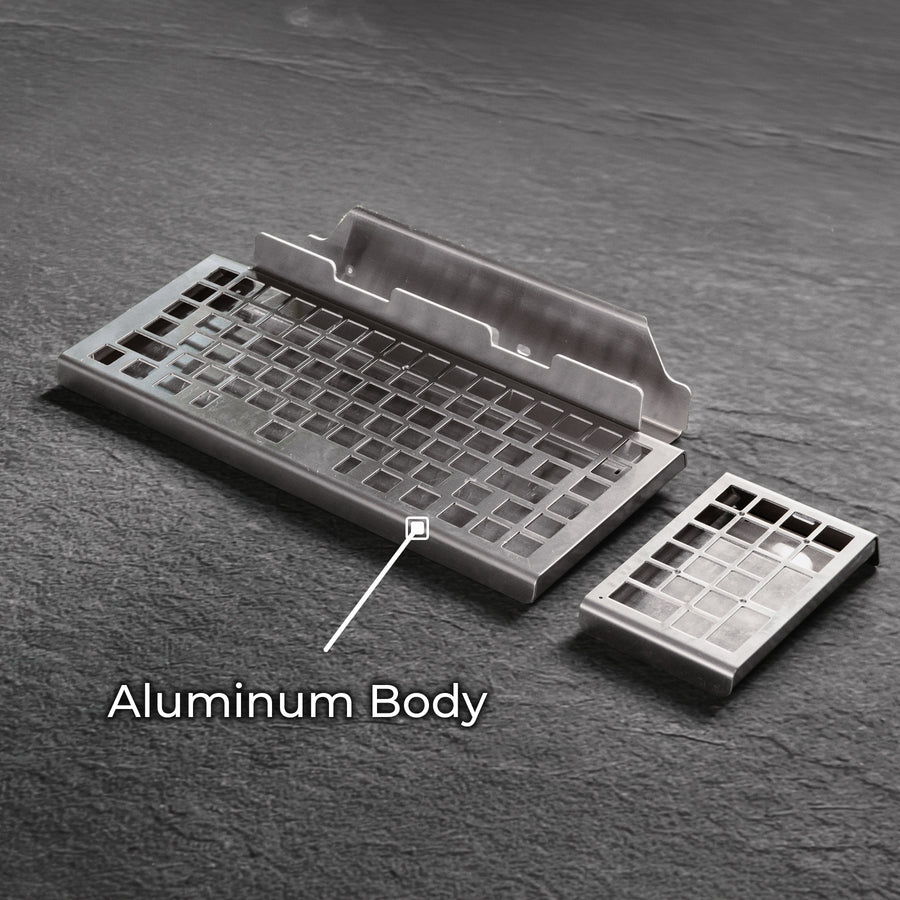 Qwerkywriter typewriter keyboard best in class premium all aluminum body on dark gray stone background aluminum chassis body