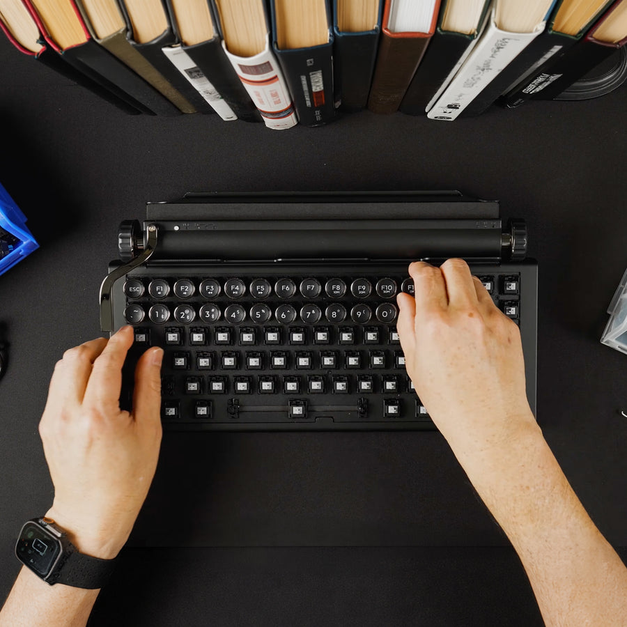 Qwerkywriter typewriter keyboard best in class premium all aluminum body switch installation on black desktop with books