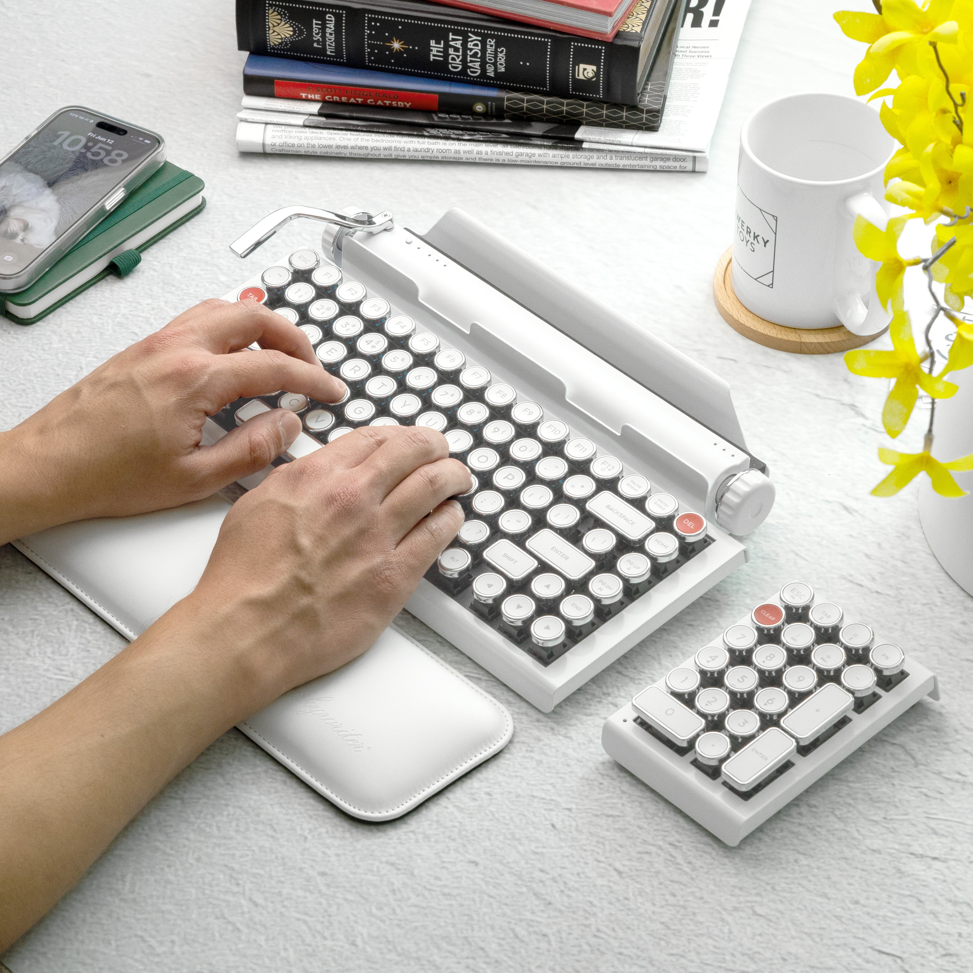 Qwerkywriter typewriter keyboard best in class premium all aluminum body in white chrome on white background person typing