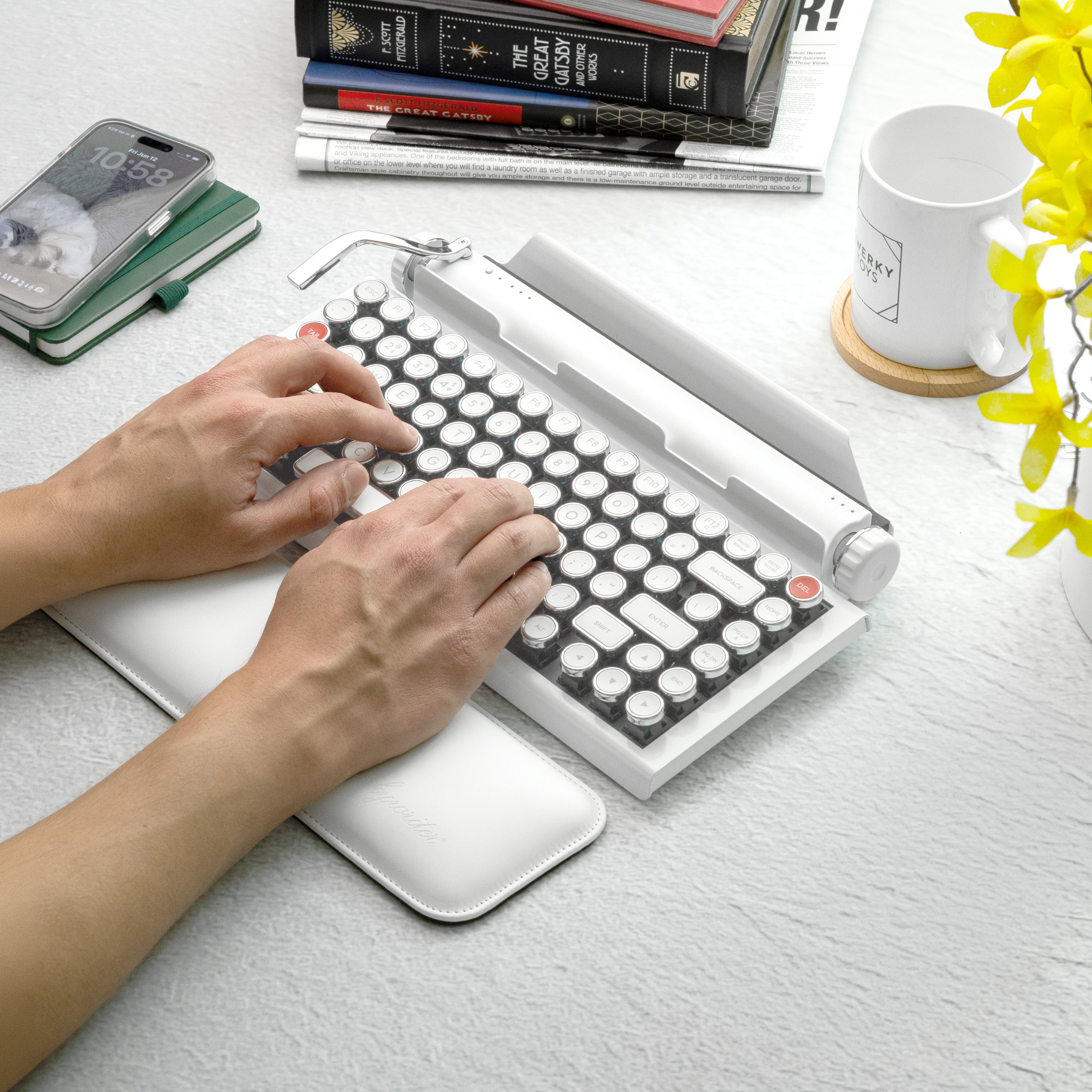 Qwerkywriter typewriter keyboard best in class premium all aluminum body in white chrome on white background person typing
