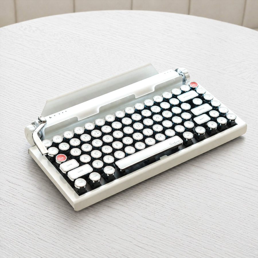 Qwerkywriter typewriter keyboard best in class premium all aluminum body in white chrome on light wood table hero image