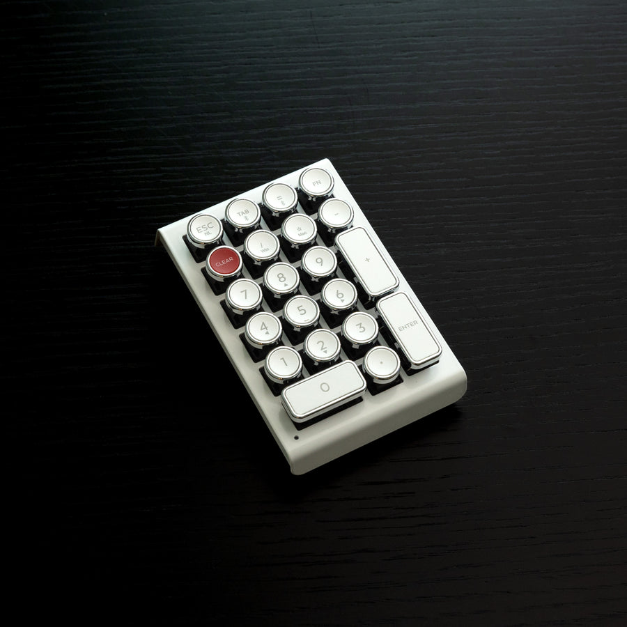 Qwerkywriter typewriter keyboard numkey numpad best in class premium all aluminum body in white chrome left side view on black wood grain 