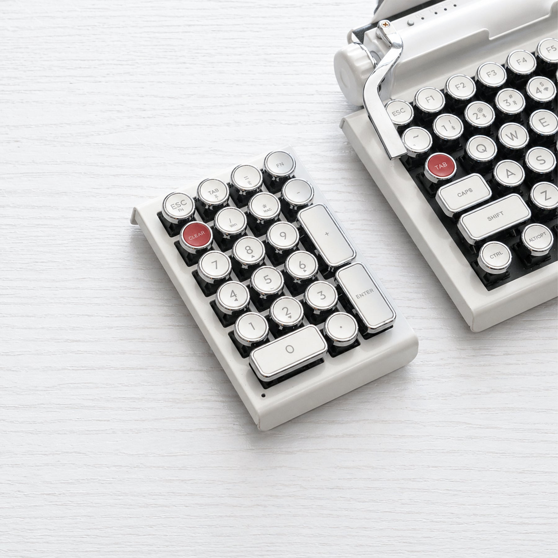 Qwerkywriter typewriter keyboard numkey numpad best in class premium all aluminum body in white chrome left side view on white wood grain with Qwerkywriter white chrome typewriter keyboard