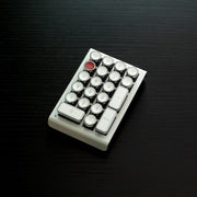 Qwerkywriter typewriter keyboard numkey numpad best in class premium all aluminum body in white chrome right side view on black wood grain 