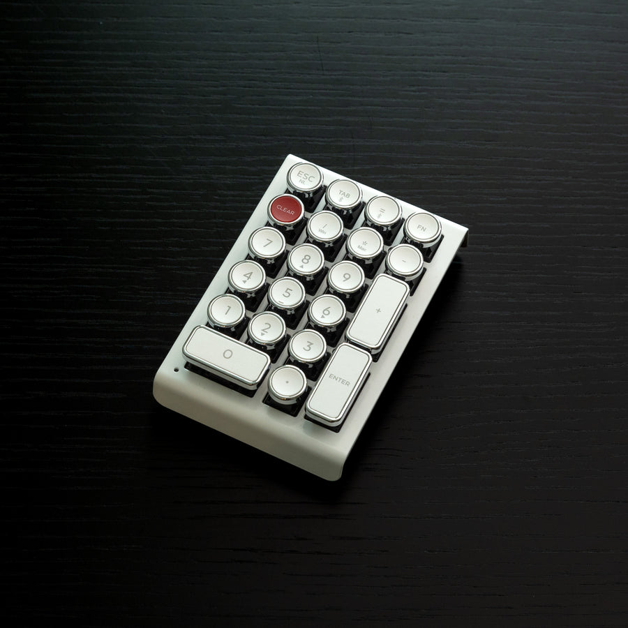Qwerkywriter typewriter keyboard numkey numpad best in class premium all aluminum body in white chrome right side view on black wood grain 
