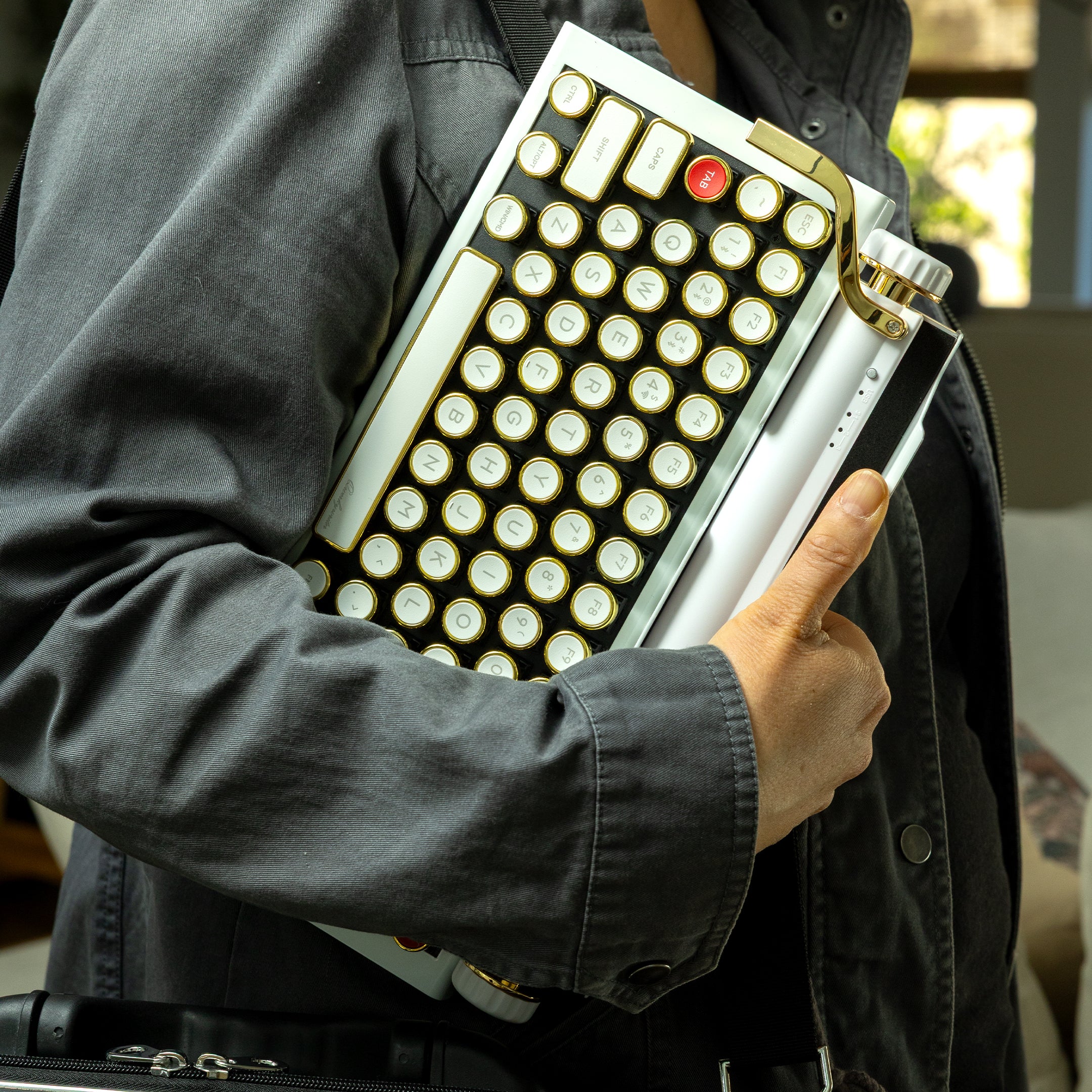 Qwerkywriter typewriter keyboard best in class premium all aluminum body in white gold with jean jacket walking and carrying