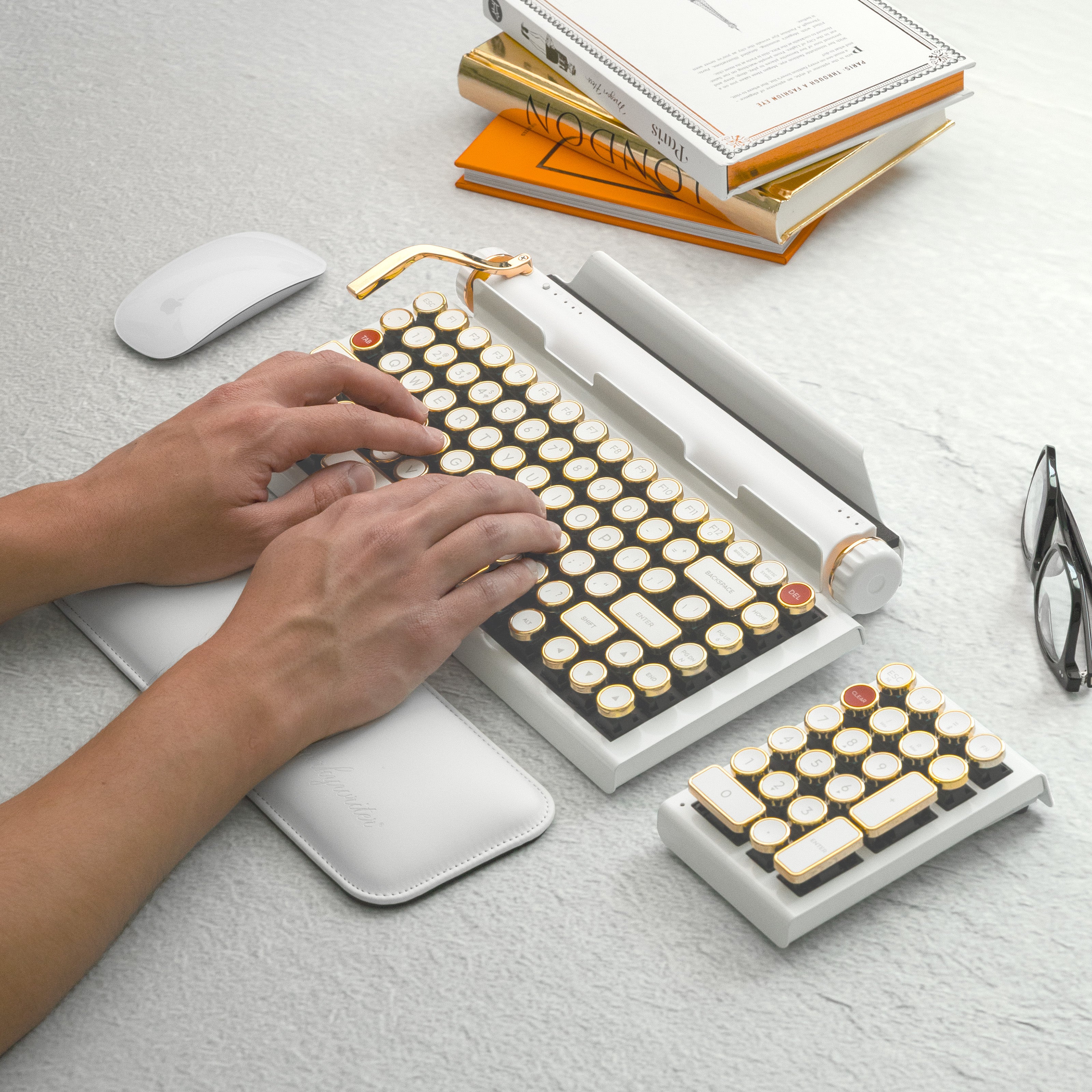 Qwerkywriter typewriter keyboard best in class premium all aluminum body in white gold typing on light stone background desk