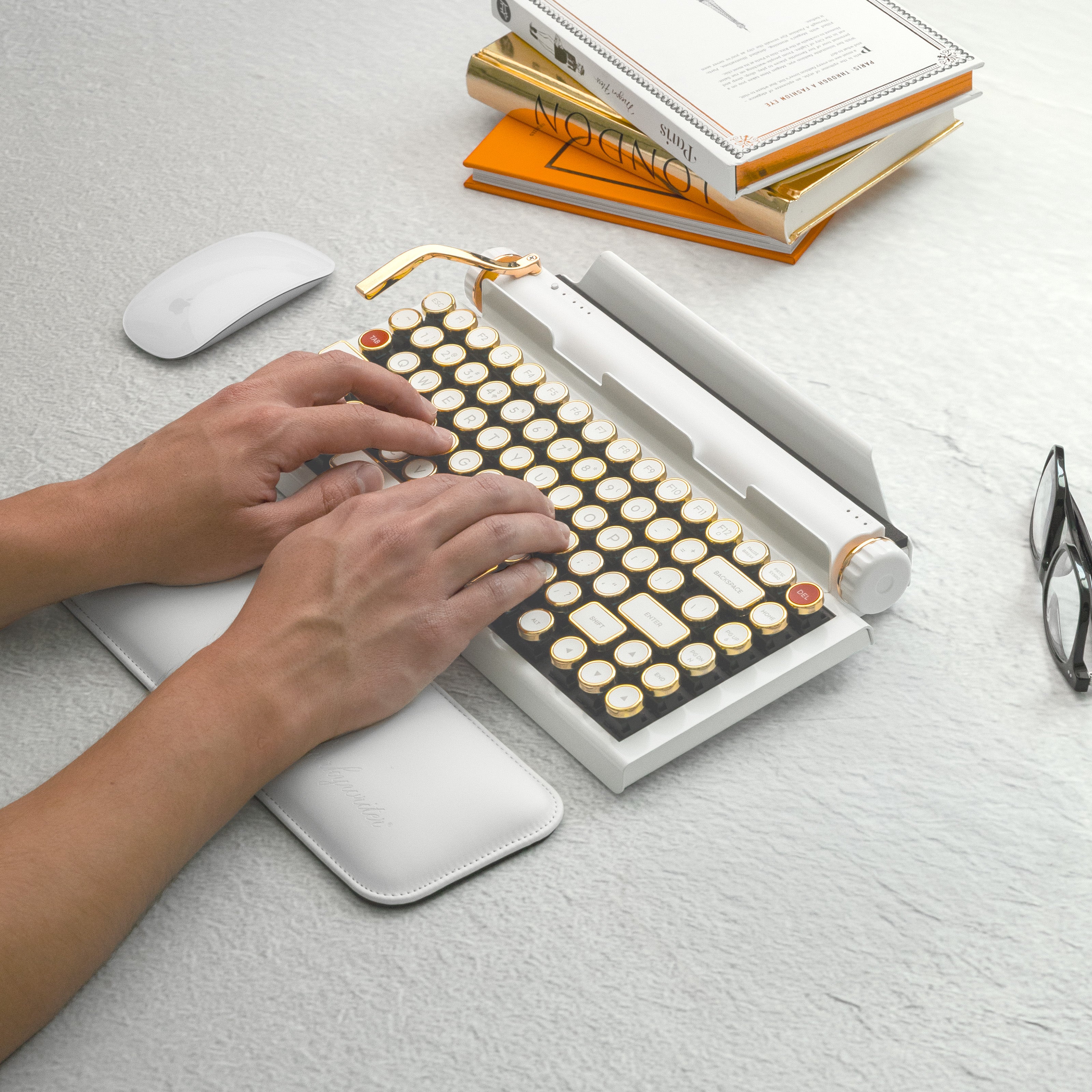 Qwerkywriter typewriter keyboard best in class premium all aluminum body in white gold typing on light stone background desk