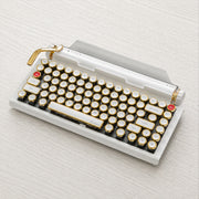 Qwerkywriter typewriter keyboard best in class premium all aluminum body in white gold on light color wood table