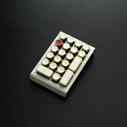 Qwerkywriter typewriter keyboard numkey numpad best in class premium all aluminum body in white gold left side view on black wood grain 