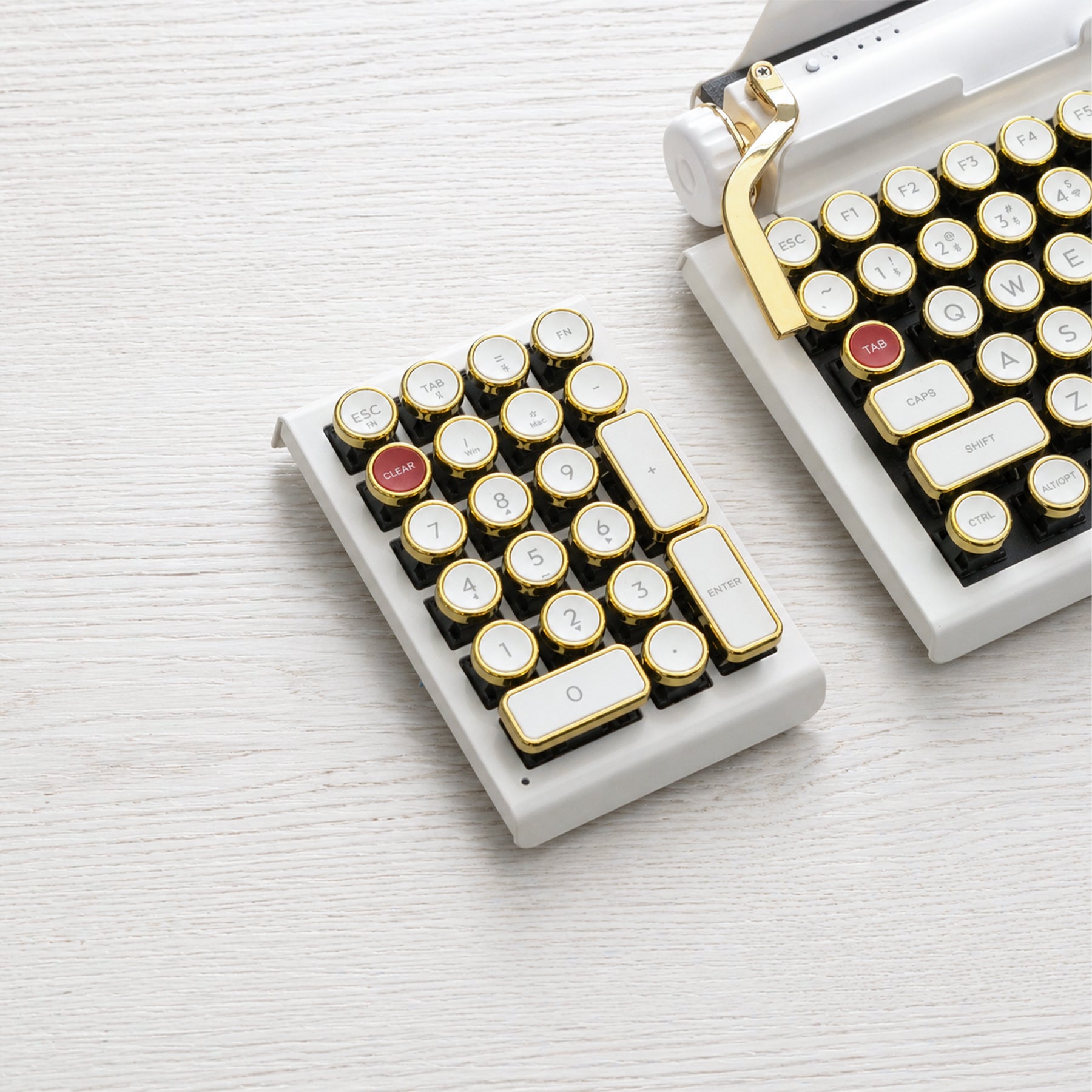 Qwerkywriter typewriter keyboard numkey numpad best in class premium all aluminum body in white gold front view on white wood grain 