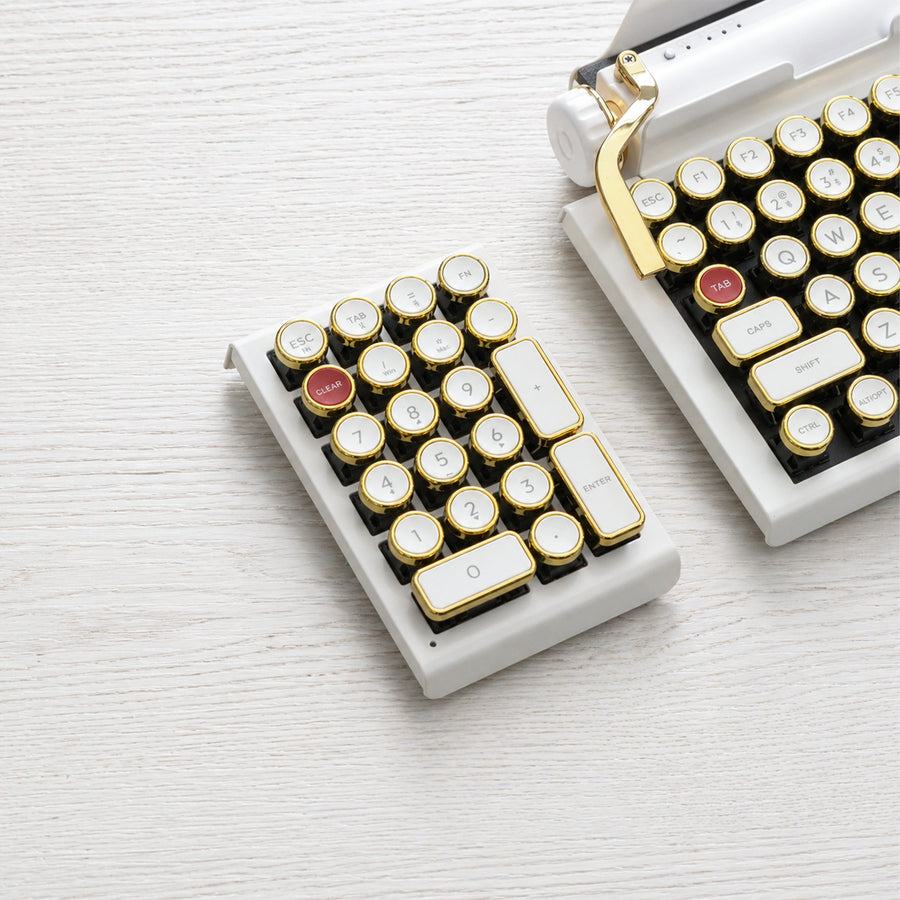 Qwerkywriter typewriter keyboard numkey numpad best in class premium all aluminum body in white gold front view on white wood grain 