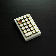 Qwerkywriter typewriter keyboard numkey numpad best in class premium all aluminum body in white gold right side view on black wood grain 
