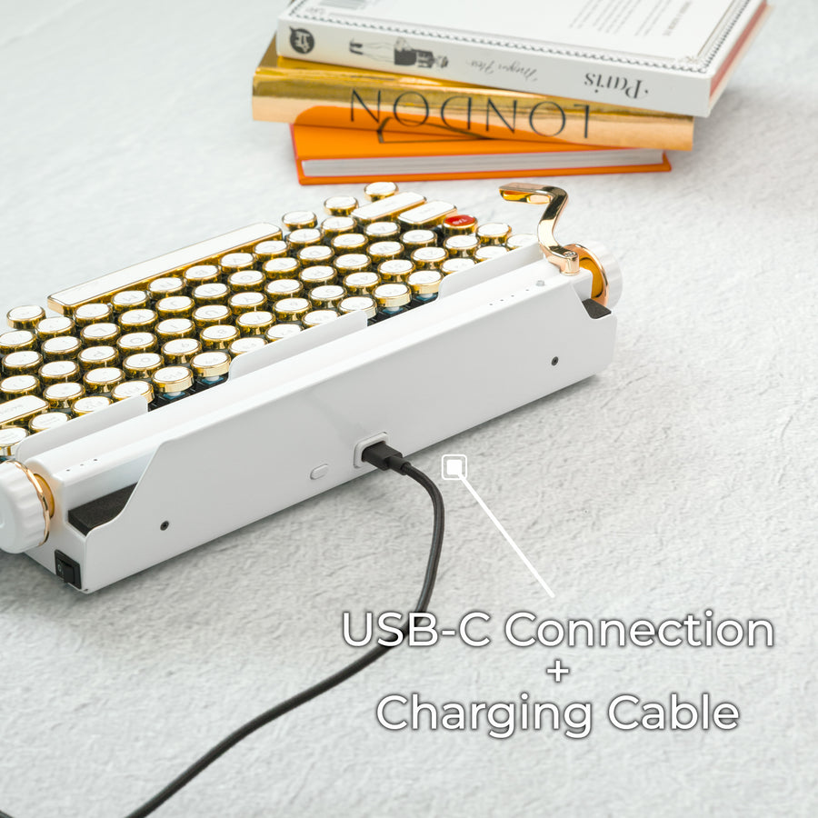 Qwerkywriter typewriter keyboard best in class premium all aluminum body in white gold on light background with USB C charging and connection cable with dongle